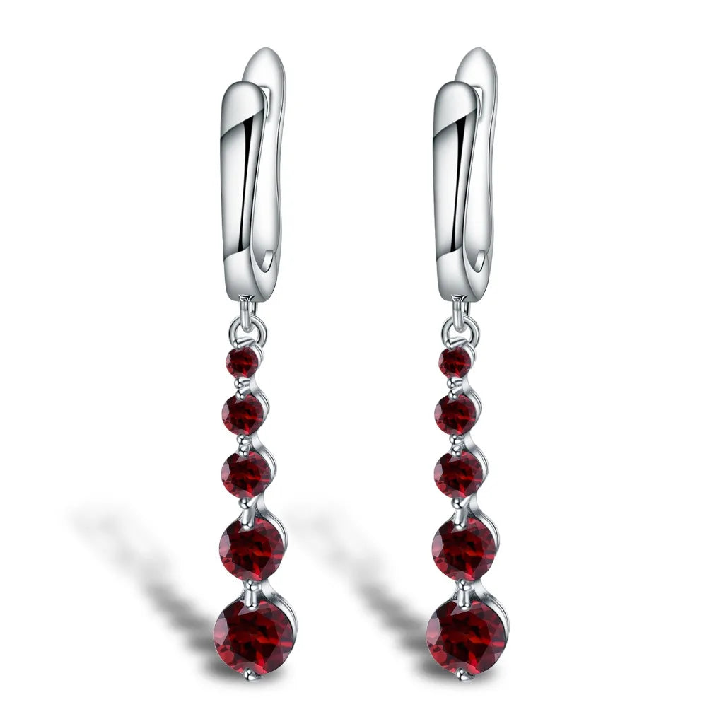 Silver drop earrings featuring a vertical cascade of five round garnet-red stones, from the Rossa Collection.

