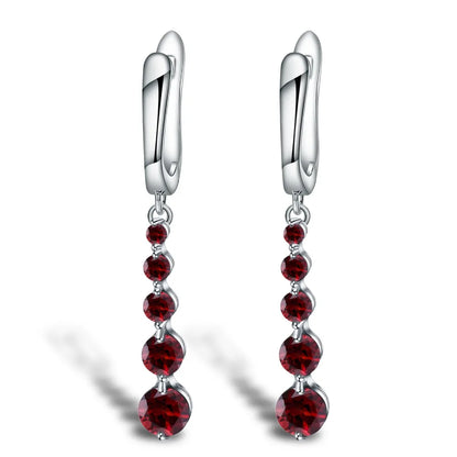 Silver drop earrings featuring a vertical cascade of five round garnet-red stones, from the Rossa Collection.

