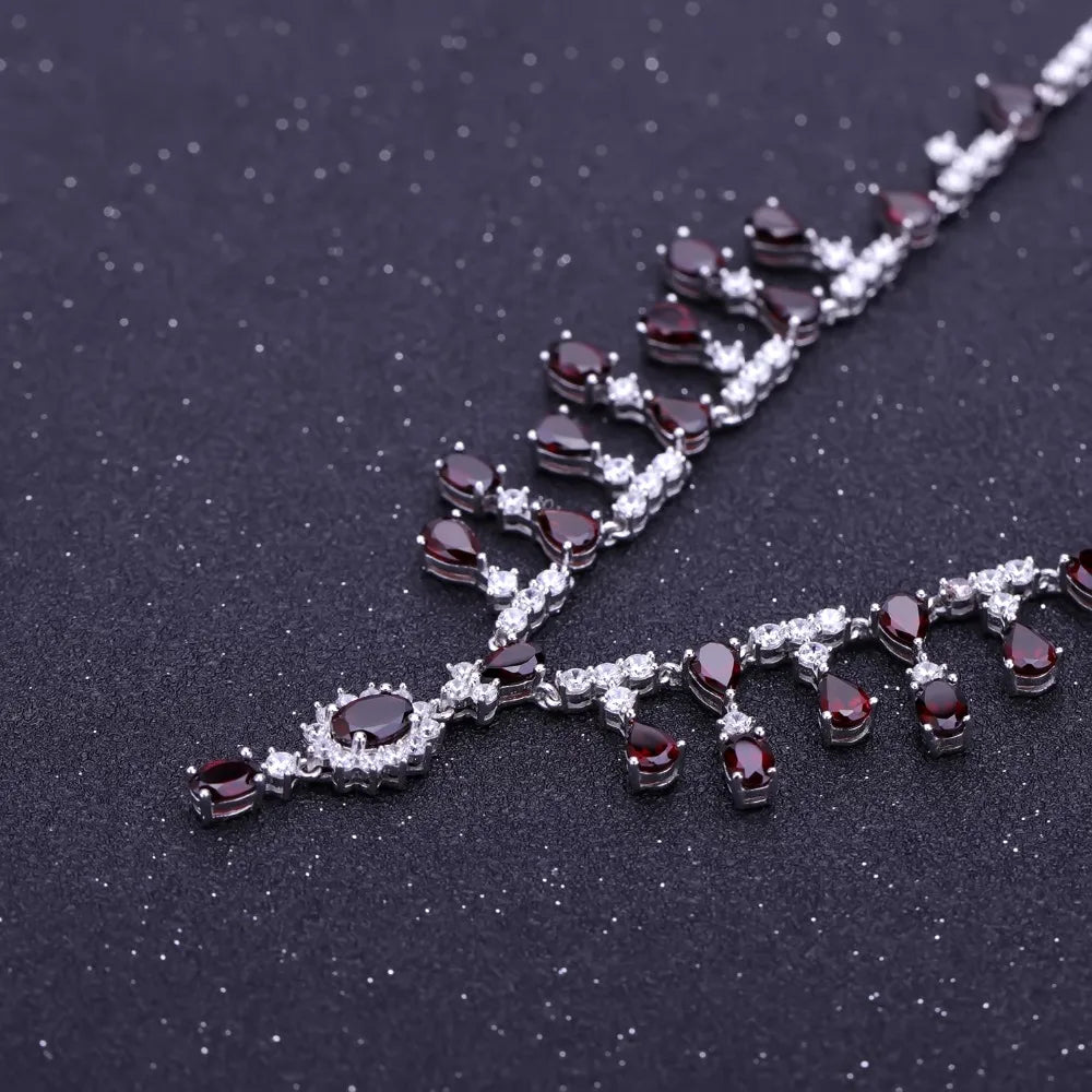 Necklace with red gemstones and clear stones on a black background