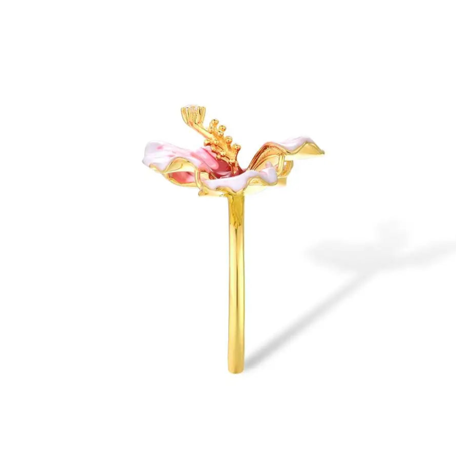 Prato ring shaped like a blooming hibiscus flower in pink enamel with golden stamen and a single sparkling white stone.

