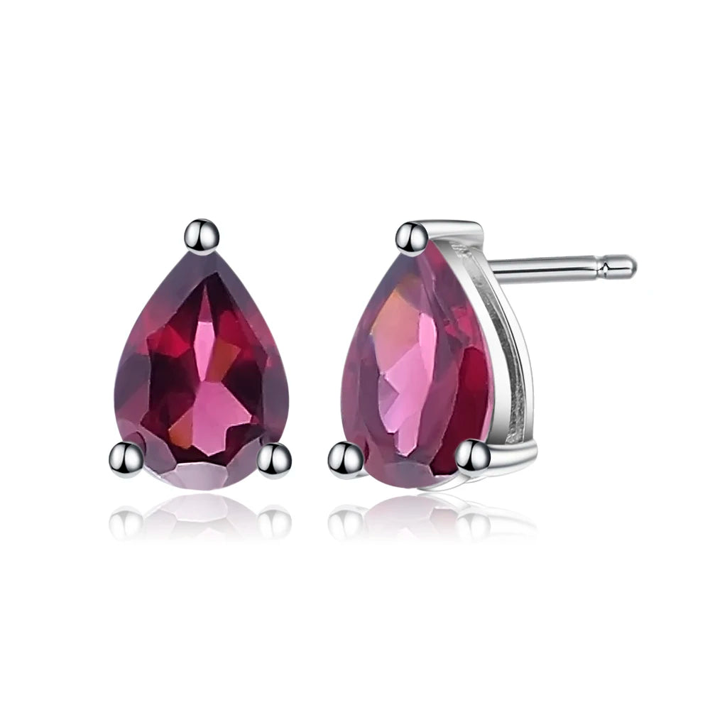 Pear-cut red gemstone stud earrings set in silver-tone prongs.

