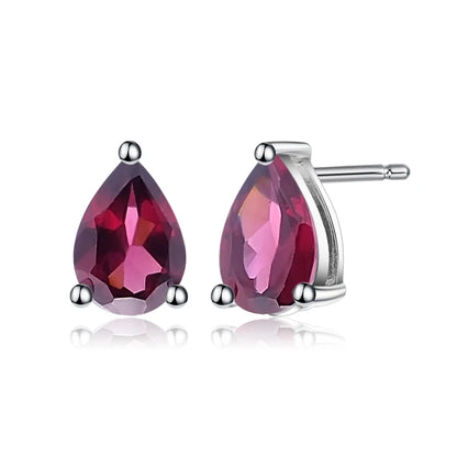 Pear-cut red gemstone stud earrings set in silver-tone prongs.

