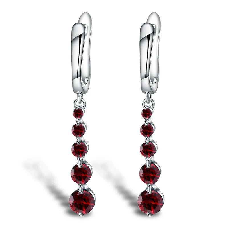 Silver drop earrings featuring a vertical cascade of five round garnet-red stones, from the Rossa Collection.

