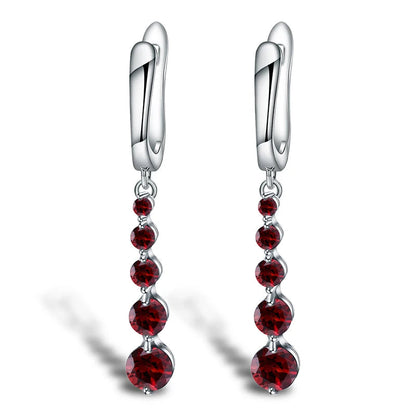 Silver drop earrings featuring a vertical cascade of five round garnet-red stones, from the Rossa Collection.

