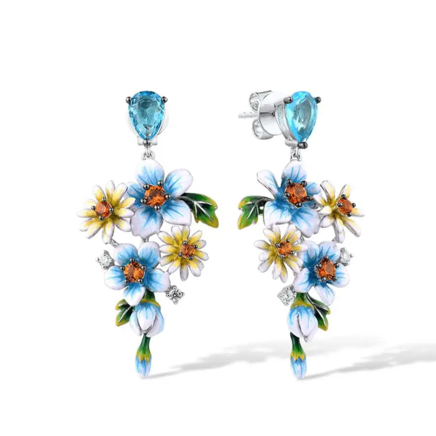 Sterling silver floral drop earrings with blue enamel flowers and orange gemstone centers

