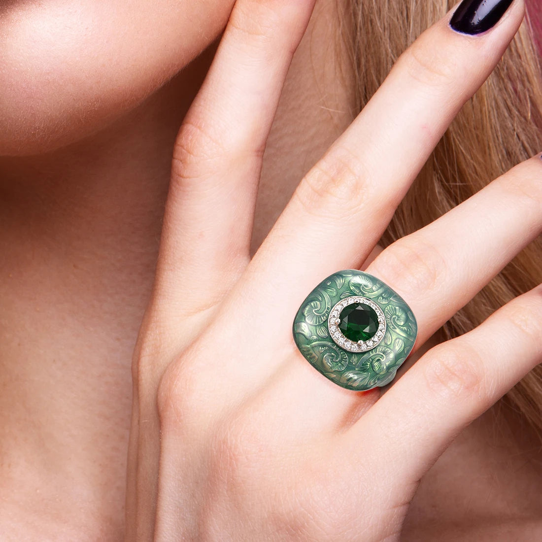 Square green enamel ring with engraved floral design and central green gemstone

