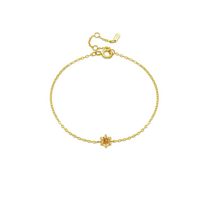 Delicate silver bracelet featuring a single round red stone set at the center.

