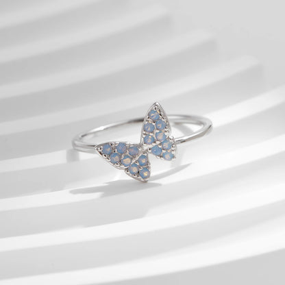 Sterling silver ring with a delicate butterfly shape inlaid with shimmering opal stones


