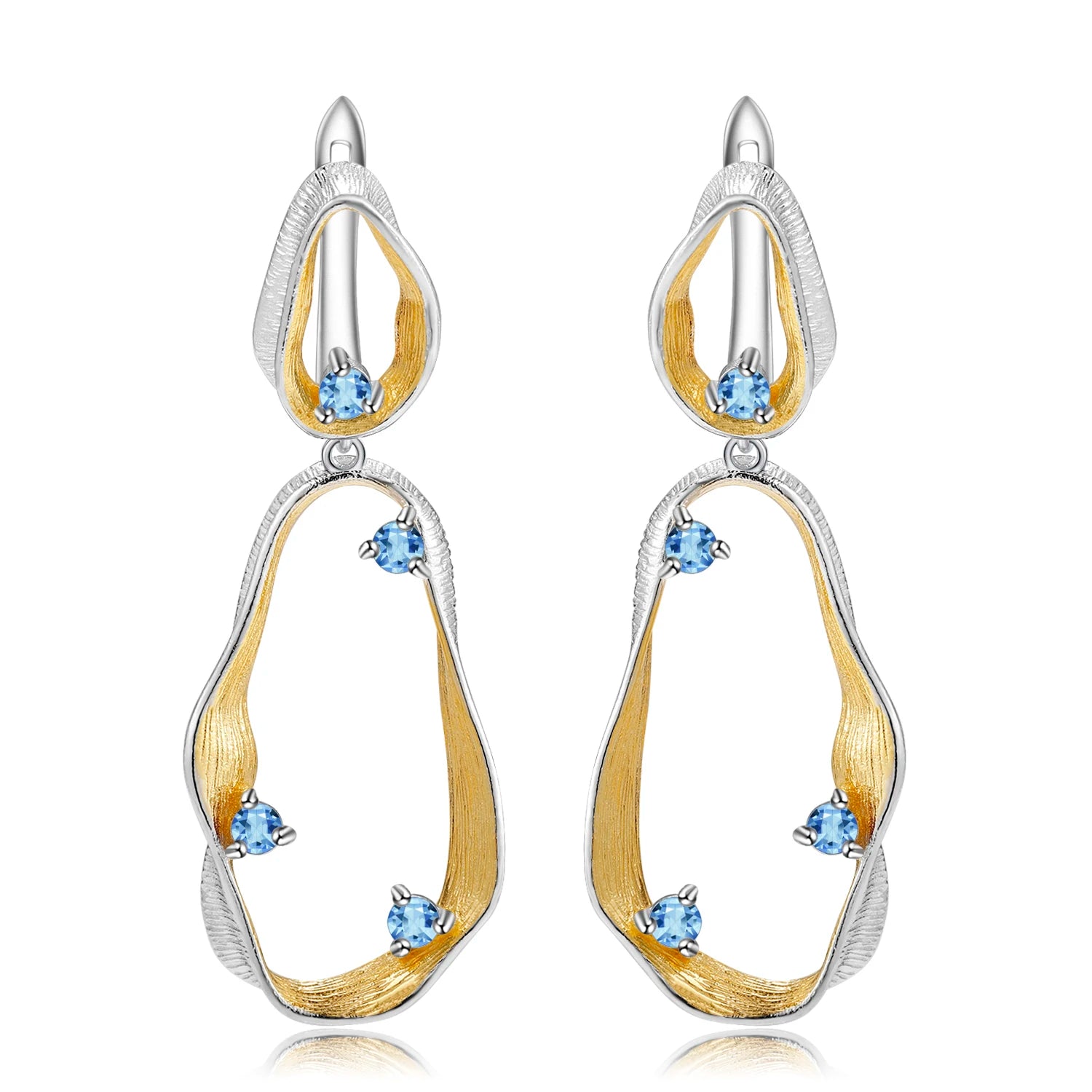 Dangling earrings with flowing gold and silver forms set with turquoise-colored stones

