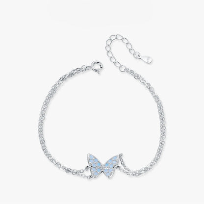 Delicate silver bracelet with a central opal butterfly charm and fine double chain

