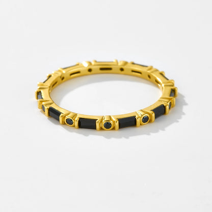 Gold ring with alternating black baguette and round stones in eternity style

