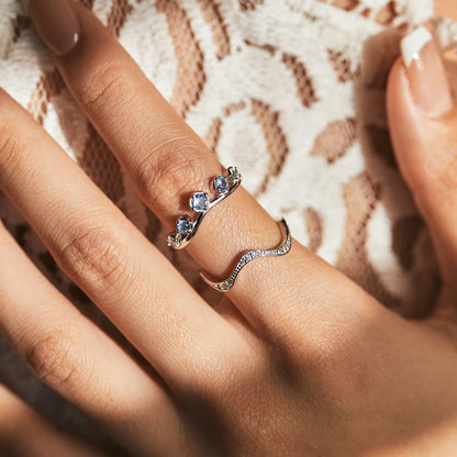 Sterling silver ring with six graduated light blue and lavender stones set in a tiara-like arc

