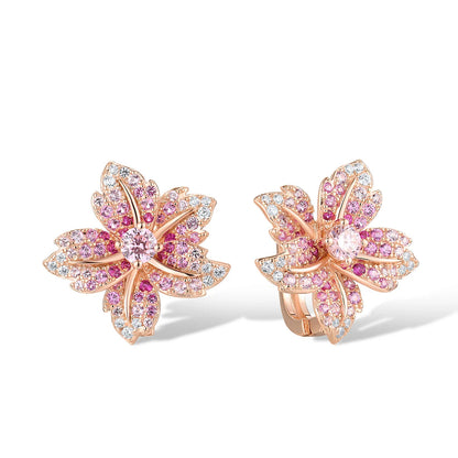 Rose gold floral earrings shaped like lilies, adorned with pink and clear pavé stones.

