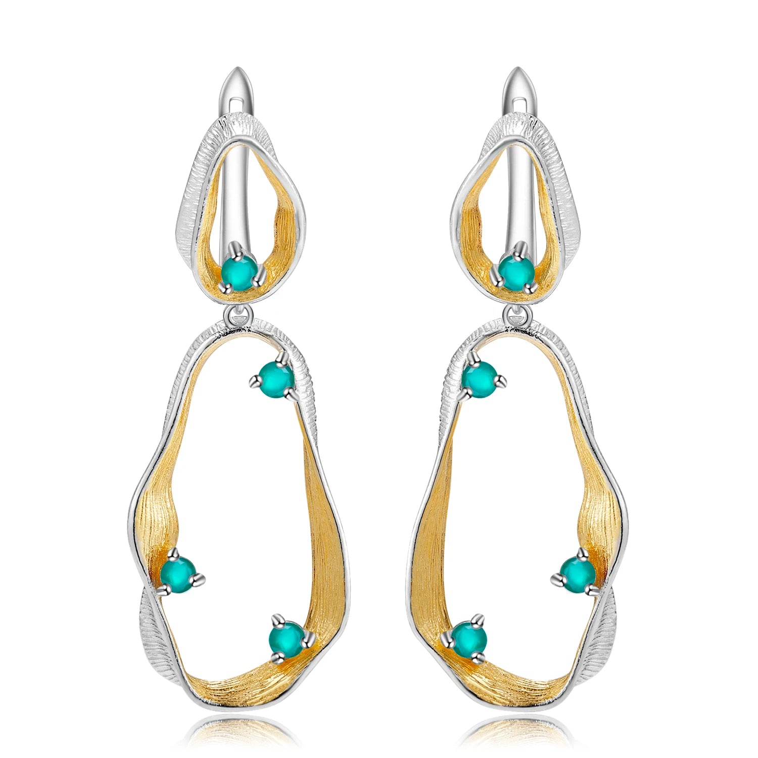 Dangling earrings with flowing gold and silver forms set with turquoise-colored stones

