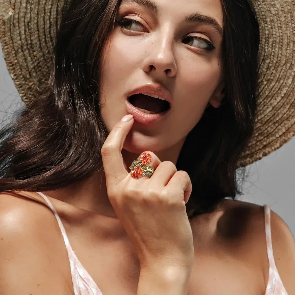 Gold ring with vibrant orange floral gemstones and soft green leaf-shaped stones, Fiore di Cristallo from the Rossa Collection.

