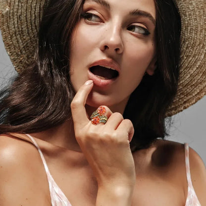 Gold ring with vibrant orange floral gemstones and soft green leaf-shaped stones, Fiore di Cristallo from the Rossa Collection.

