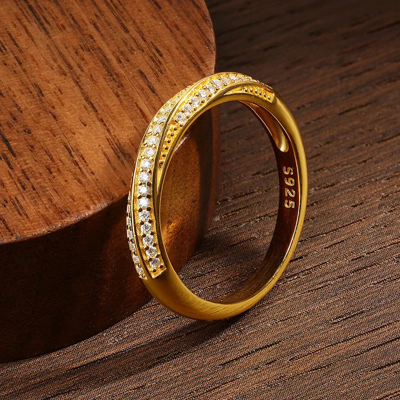 Slim silver ring featuring two parallel rows of small white stones, forming a subtle twist in the center, from the Bianco Nero collection.

