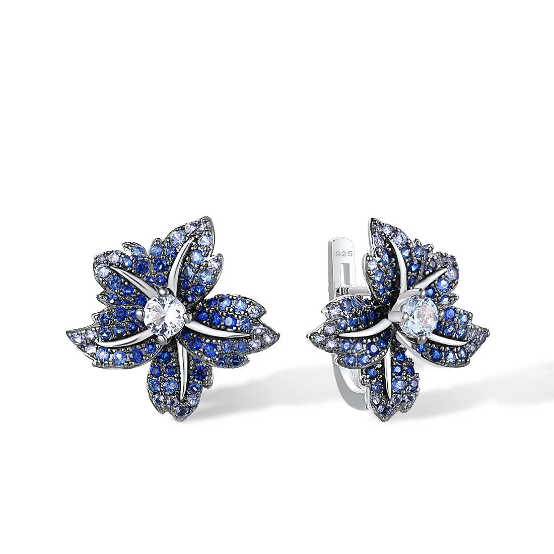 Silver earrings shaped like lilies, encrusted with deep blue and white stones

