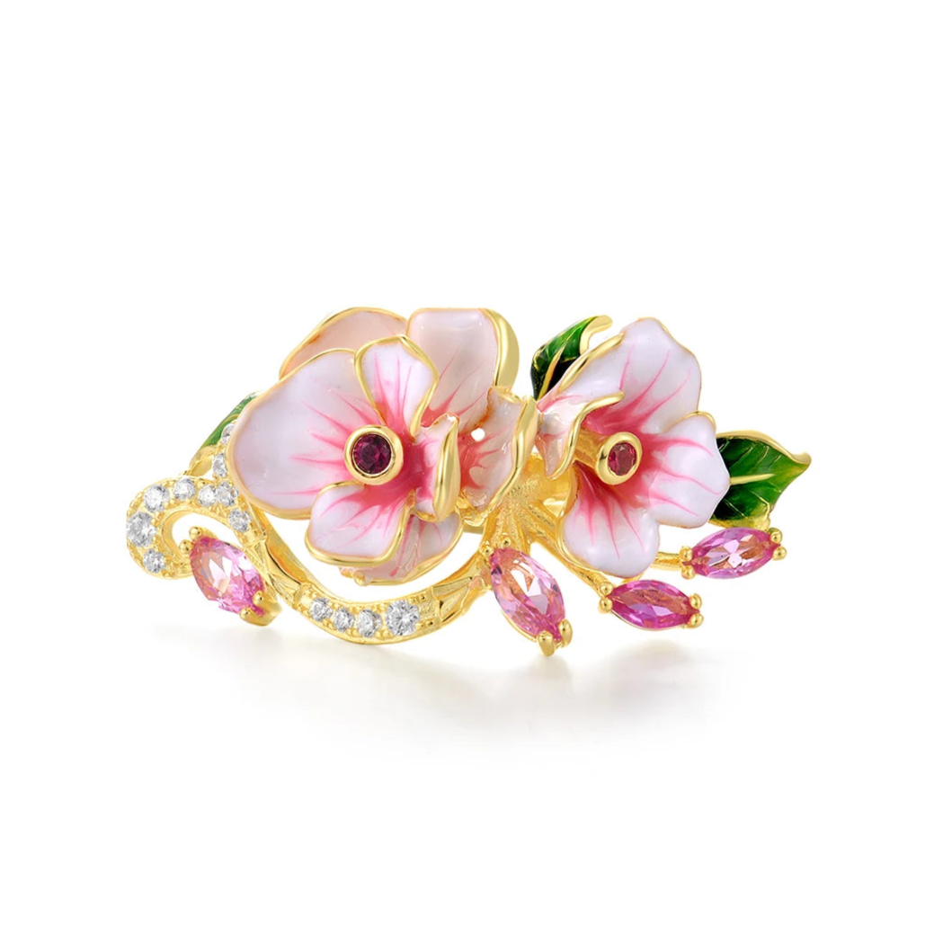 Prato ring with hand-painted pink flowers, green enamel leaves, and pink marquise-cut stones on a gold band.

