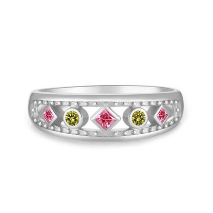 Gold ring with alternating pink square-cut and green round gemstones, framed by beaded detailing, displayed on a red background.


