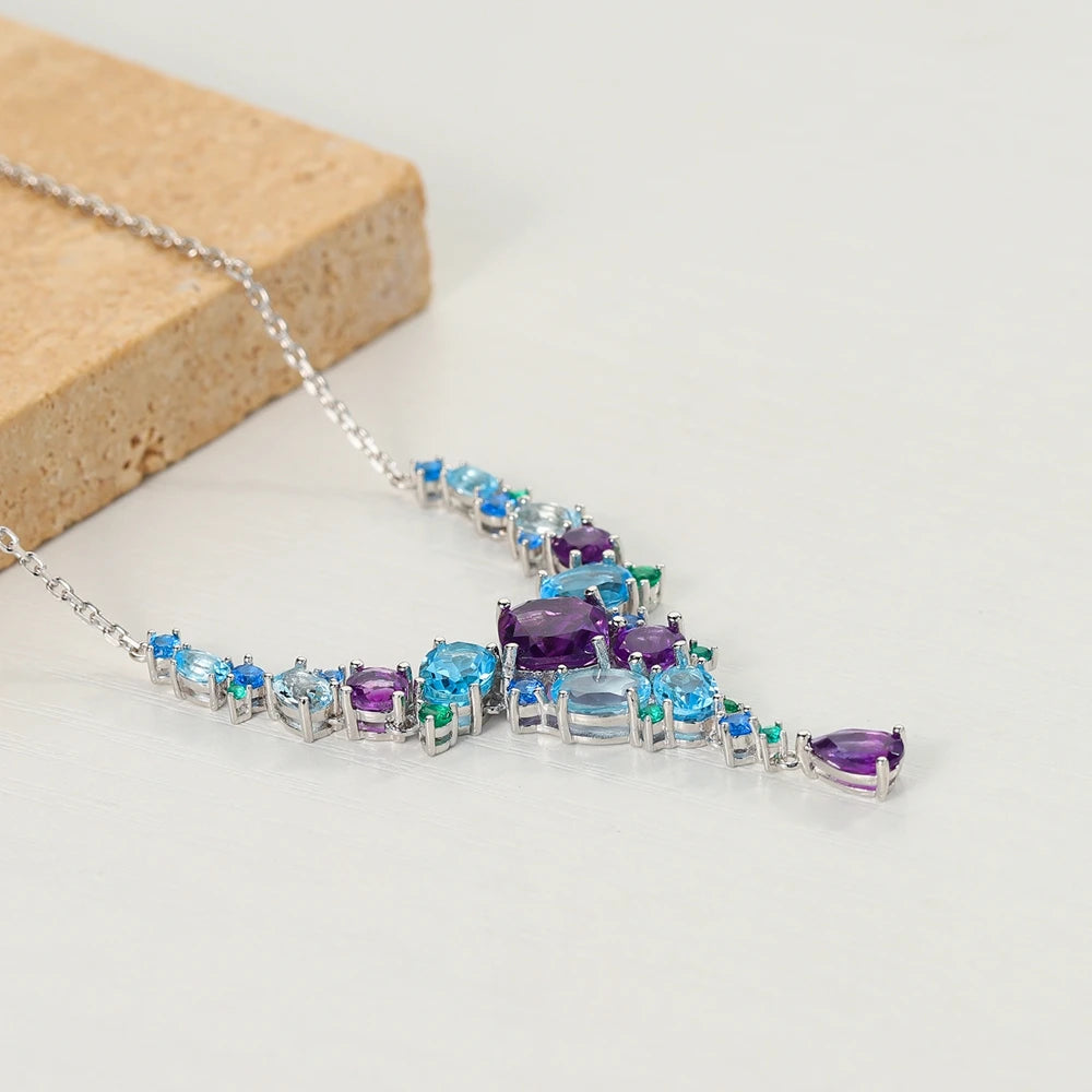Necklace with gradient blue and green gemstones arranged in an organic cascading pattern

