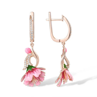 Fiore Pressato earrings shaped like delicate pink bell flowers, accented with green and gold enamel and sparkling stones.

