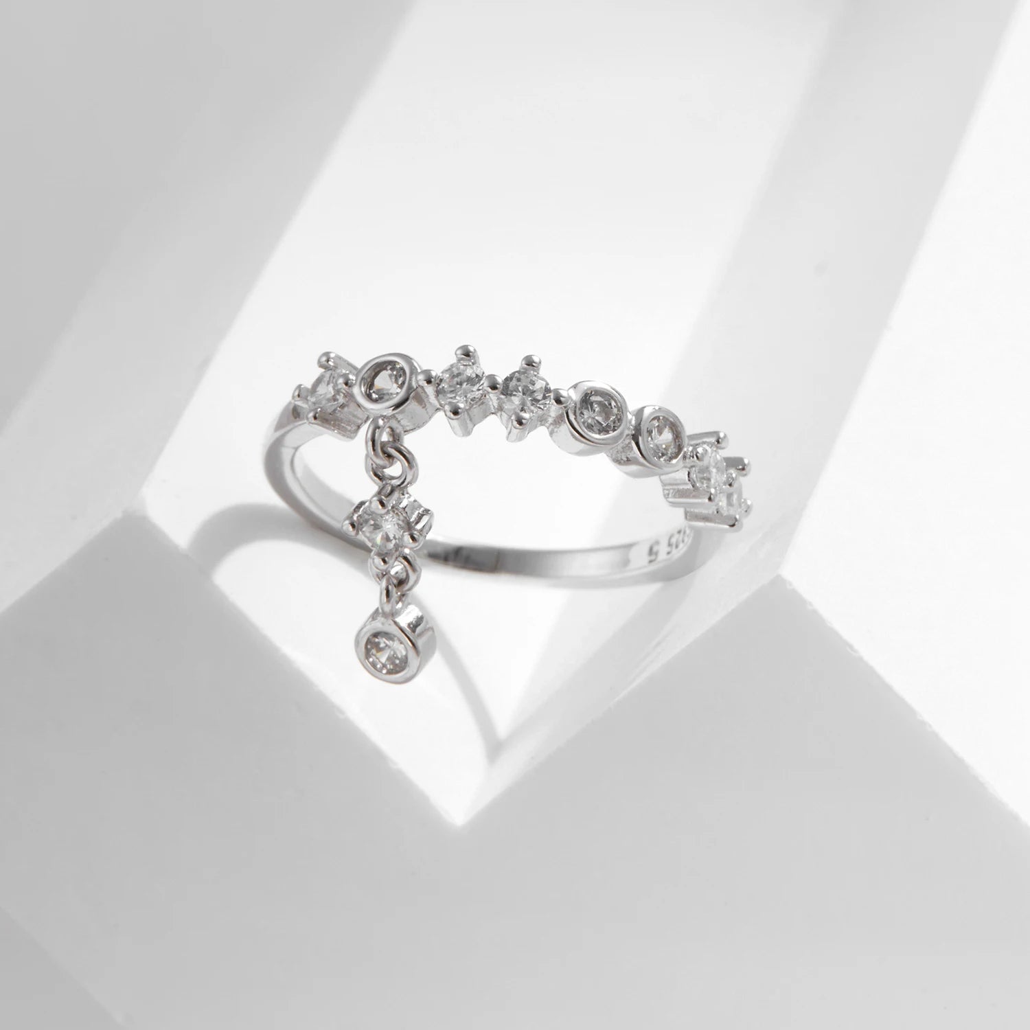Silver ring with a line of round-cut stones and three delicate cubic zirconia drops