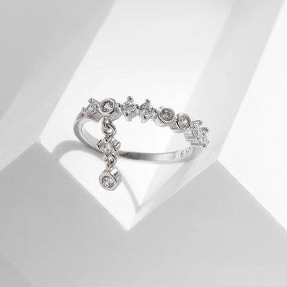 Silver ring with a line of round-cut stones and three delicate cubic zirconia drops