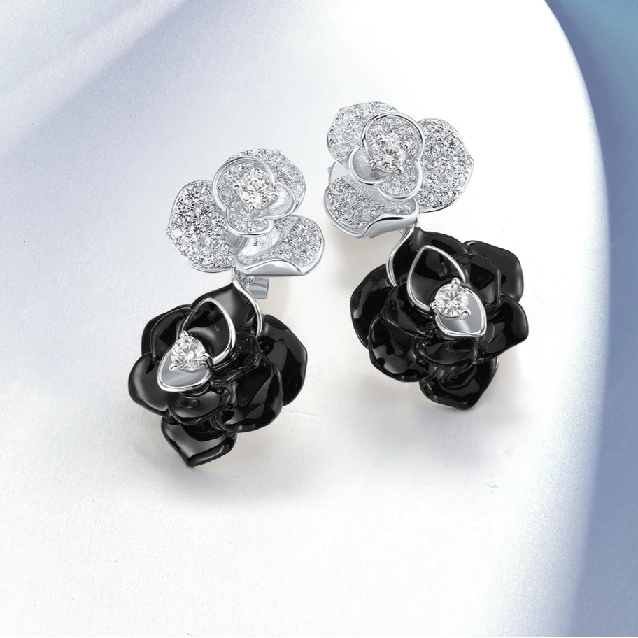 Silver and black enamel earrings shaped like layered roses with pavé accents

