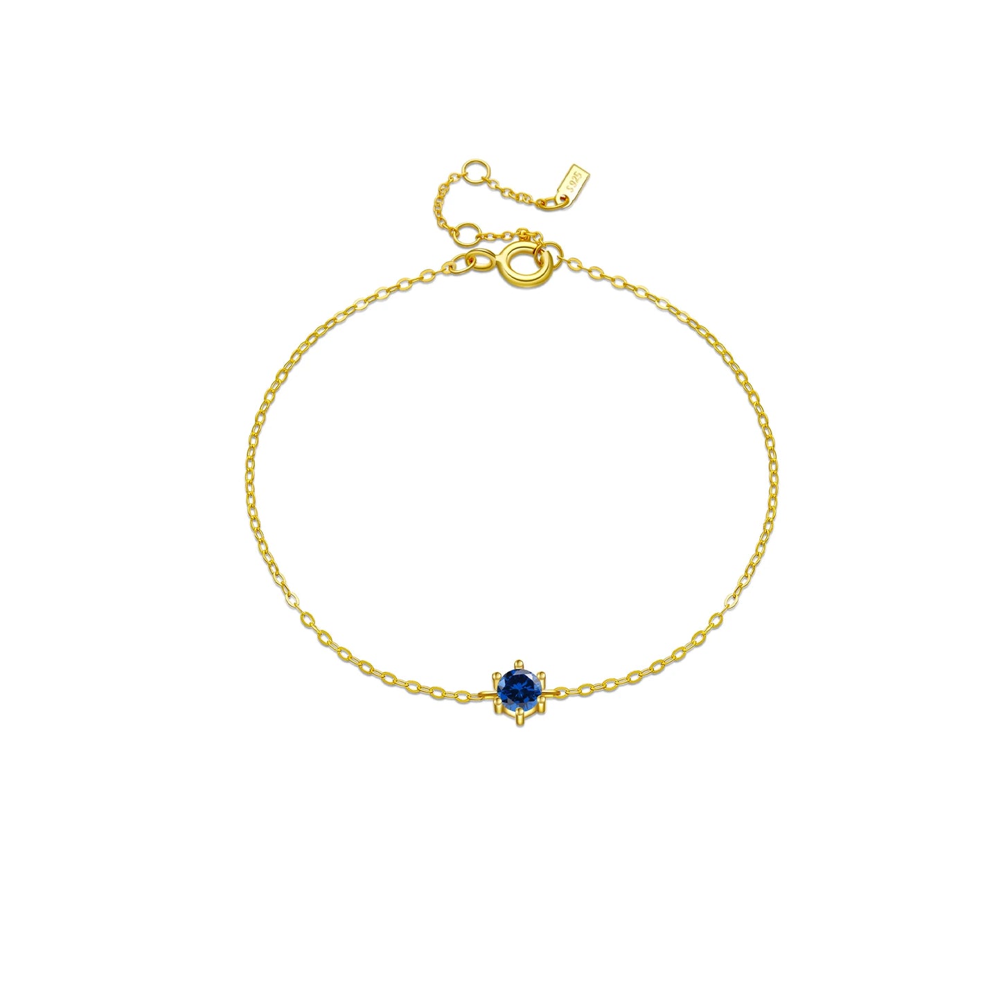Delicate silver chain bracelet with a single round deep blue gemstone in a minimalist prong setting