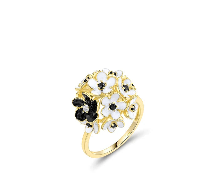 Fiore Scuro jewelry set featuring gold-tone earrings, ring, and pendant with white and black floral detailing from the Bianco Nero collection.

