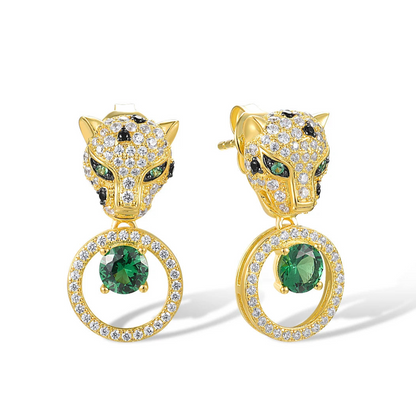Gold earrings with panther head design, sparkling black and white stones, and green gemstone drop in circular setting

