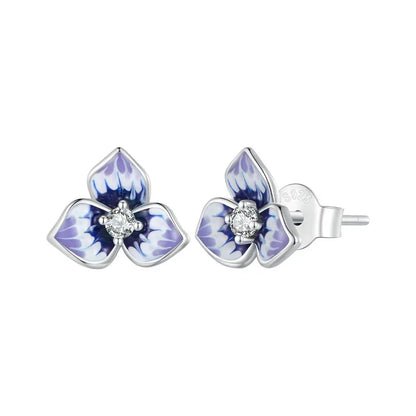 Sterling silver stud earrings shaped like purple enamel orchid flowers with a clear round gemstone at the center