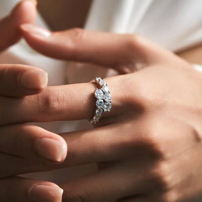 Sterling silver ring with a diagonal cluster of brilliant white round-cut stones in a cascading arrangement

