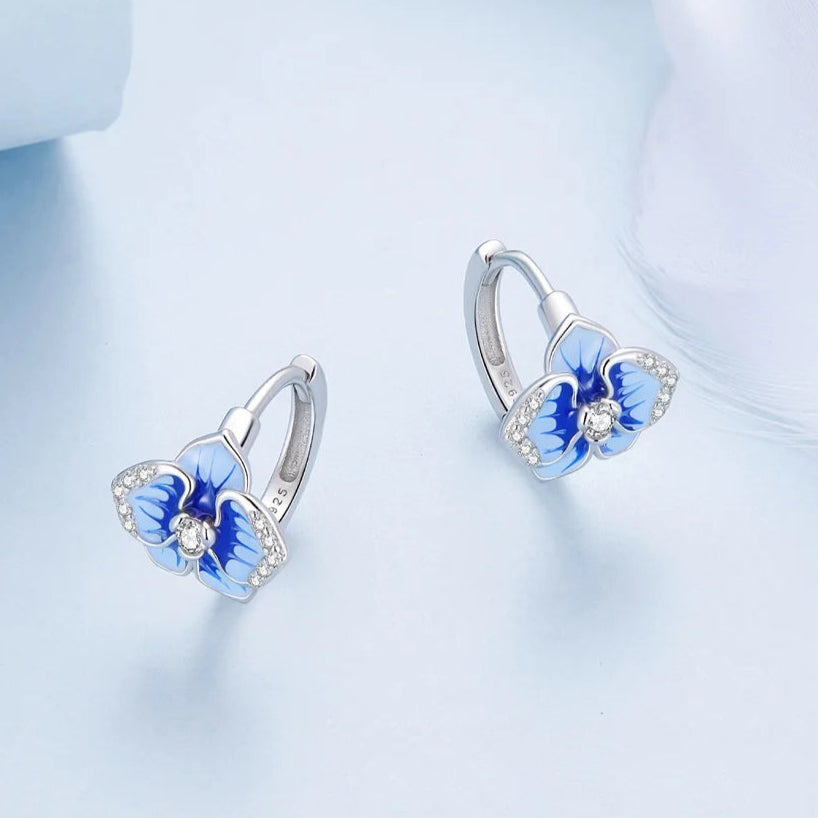 Sterling silver hoop earrings with blue enamel orchid flowers and crystal accents

