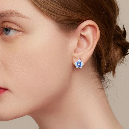 Sterling silver hoop earrings with blue enamel orchid flowers and crystal accents

