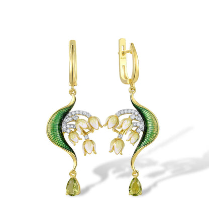 Gold drop earrings with curved green enamel leaves and cascading pink floral buds accented by pavé stones and teardrop gems

