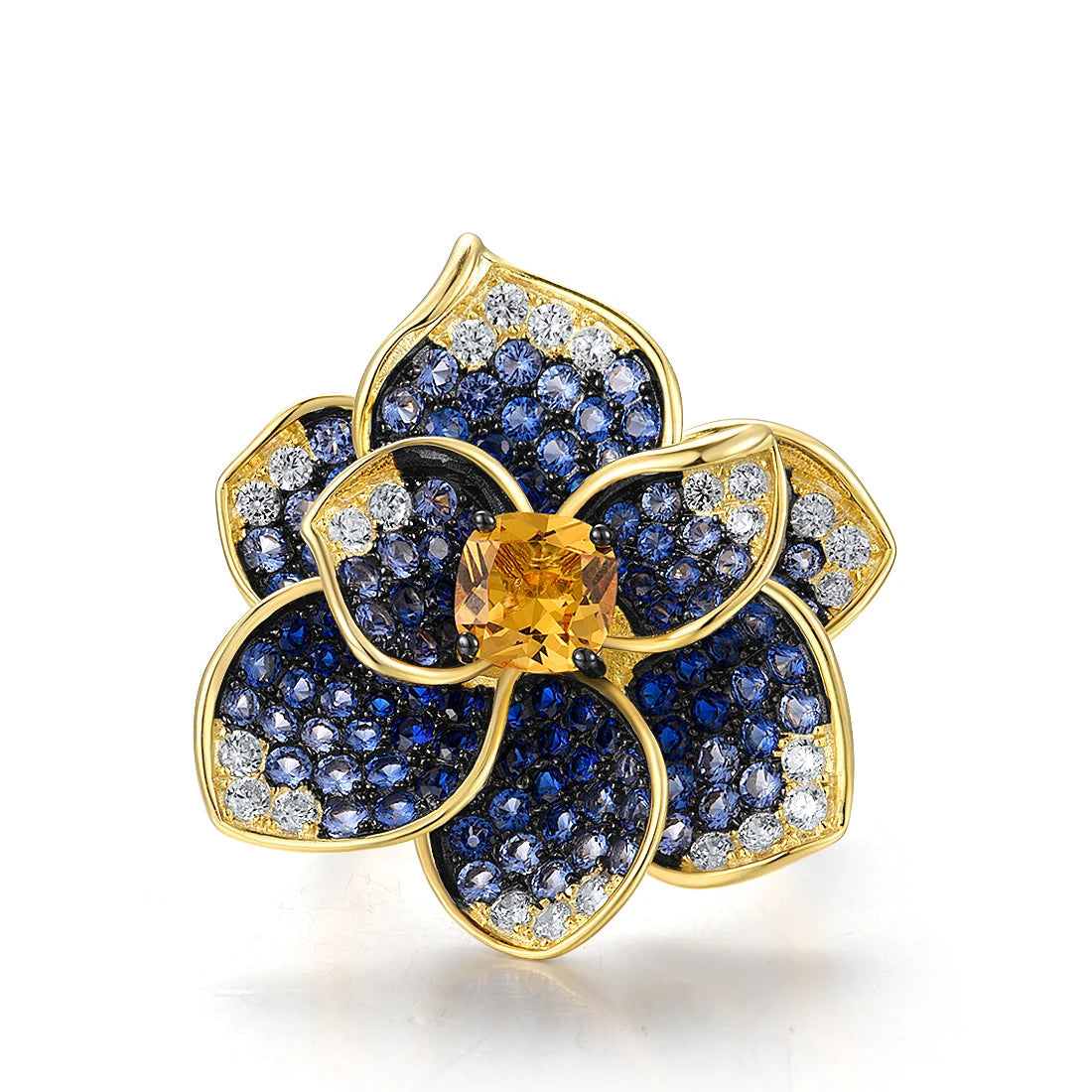 Statement floral ring in gold plating, with deep blue and clear pavé stones and a golden-yellow center gem

