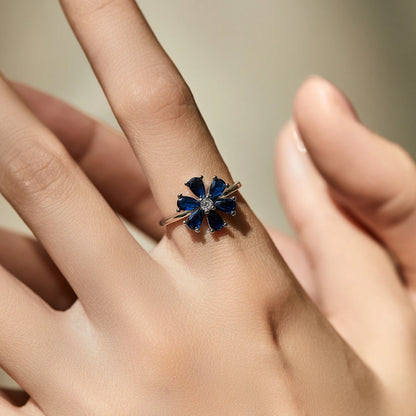 Sterling silver ring with a royal blue gemstone flower and clear stone center

