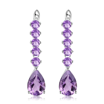 Sterling silver drop earrings with a vertical line of round amethyst stones and teardrop-shaped violet gemstones

