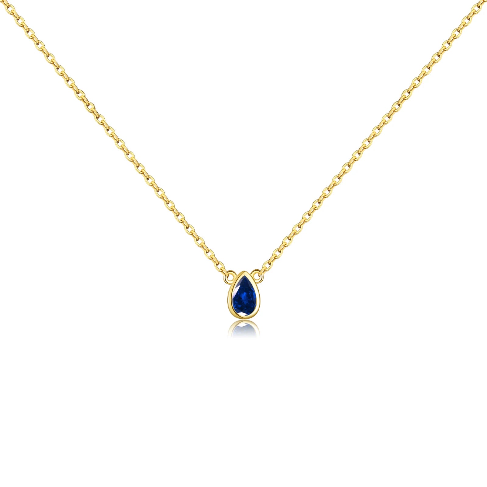 Gold chain necklace featuring a pear-shaped deep blue gemstone in a bezel setting