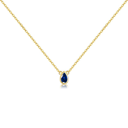 Gold chain necklace featuring a pear-shaped deep blue gemstone in a bezel setting