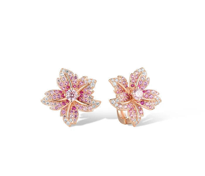 Giglio Rosa jewelry set featuring flower-shaped rose gold pieces with pink and white pavé stones, including ring, earrings, and pendant.

