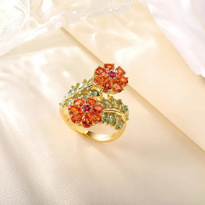 Gold ring with vibrant orange floral gemstones and soft green leaf-shaped stones, Fiore di Cristallo from the Rossa Collection.

