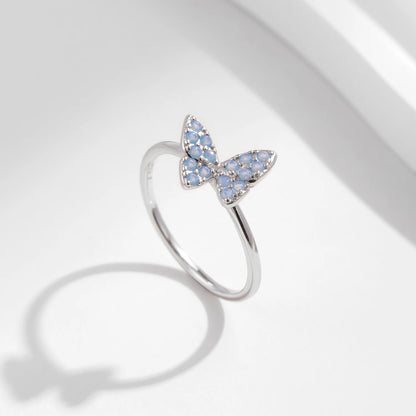 Sterling silver ring with a delicate butterfly shape inlaid with shimmering opal stones

