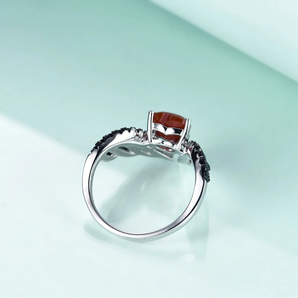 Sterling silver ring with a heart-shaped black gemstone flanked by pavé-set wing-like details, from the Ali Nere design.

