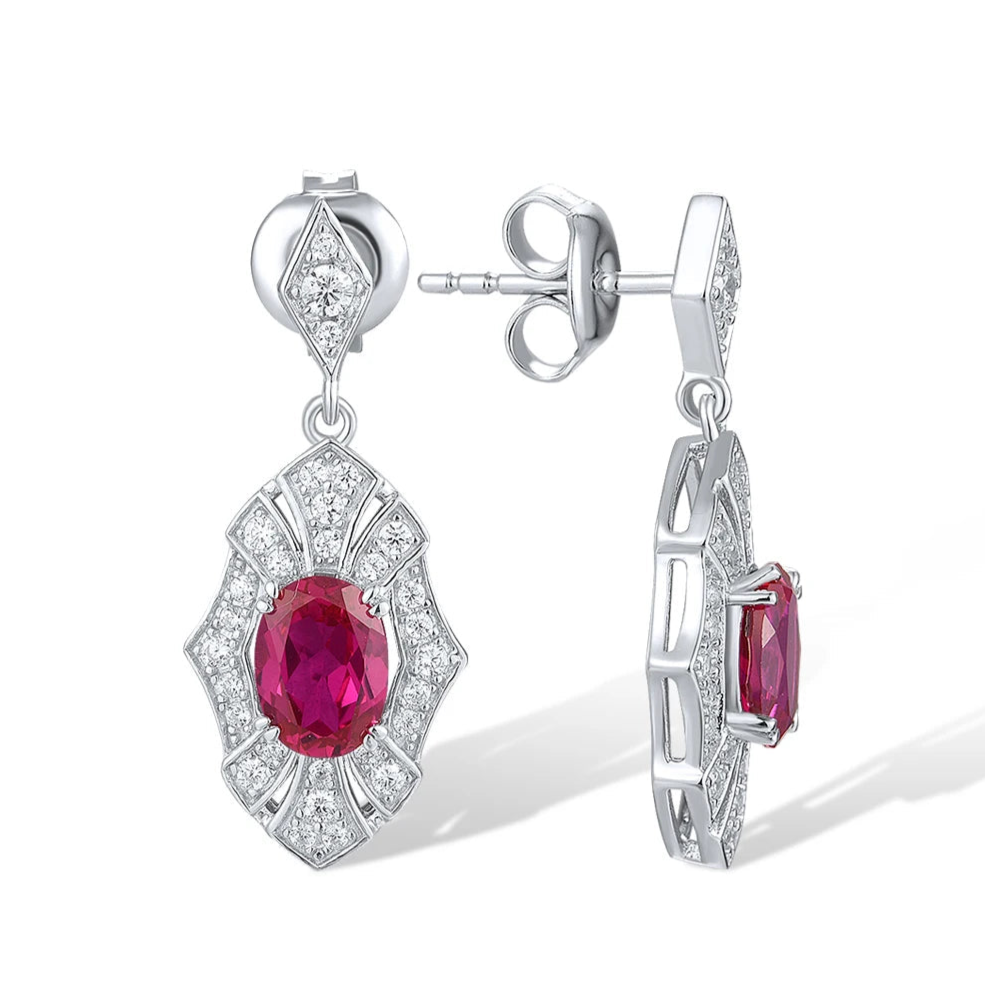 Rubino earrings with deep red oval stones framed in intricate silver settings accented by small white crystals.

