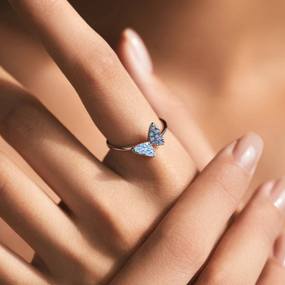 Sterling silver ring with a delicate butterfly shape inlaid with shimmering opal stones

