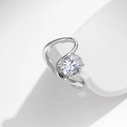 Open silver ring with a triangular wrap design, featuring a prominent oval white stone at its center, from the Bianco Nero collection.

