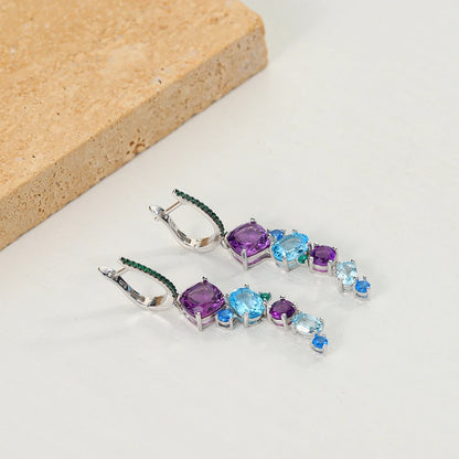 Dangling earrings with gradient blue and green stones set in silver

